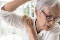 Asian old elderly woman with shoulder bone pain,stiffness and painful when raising her upper arm,suffers difficulty in lifting or