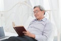 Asian Old man glasses professor enjoy reading textbook Royalty Free Stock Photo