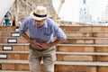 Asian old man, have an upset stomach, on the train station While he was traveling