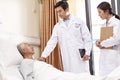 Asian old man talking to doctors in hospital ward Royalty Free Stock Photo