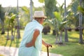 Asian old man walking in park and having a back pain, backache. Senior healthcare concept Royalty Free Stock Photo