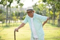 Asian old man walking in park and having a back pain, backache. Senior healthcare concept Royalty Free Stock Photo