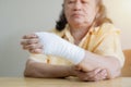 Asian old woman arm with gauze bandage on it. Sprain, stress fracture or repetitive strain injury in hand Royalty Free Stock Photo