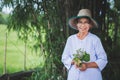 Asian old woman in hat working in the garden with smile and happy Royalty Free Stock Photo