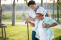 Asian old woman helping an elderly man having having a pain on heart, heart attack in a park. Senior healthcare concept Royalty Free Stock Photo