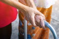 Asian old woman standing with her hands on a walker with daughter& x27;s hand,Hand of old woman holding a staff cane for helping Royalty Free Stock Photo