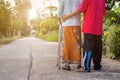 Asian old woman standing with her hands on a walker with daughter& x27;s hand,Hand of old woman holding a staff cane for helping Royalty Free Stock Photo