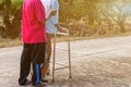 Asian old woman standing with her hands on a walker with daughter& x27;s hand,Hand of old woman holding a staff cane for helping Royalty Free Stock Photo