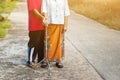 Asian old woman standing with her hands on a walker with daughter& x27;s hand,Hand of old woman holding a staff cane for helping Royalty Free Stock Photo