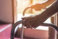 Asian old woman standing with her hands on a walker stand,Hand o Royalty Free Stock Photo