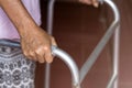 Asian old woman standing with her hands on a walker stand,Hand o Royalty Free Stock Photo