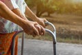 Asian old woman standing with her hands on a walking stick with daughter& x27;s hand,Hand of old woman holding a staff cane Royalty Free Stock Photo