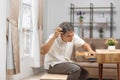 Asian older man finding something that he forgot it in drawers Royalty Free Stock Photo