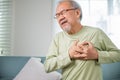 Asian older man have congenital disease suffering from heartache alone at home Royalty Free Stock Photo