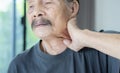 Health problem retired Asian old man hands touching and massage neck for relief pain Royalty Free Stock Photo
