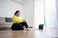 Asian overweight woman doing stretching exercise at home on fitness mat. Home activity training, online fitness class. Stretching Royalty Free Stock Photo