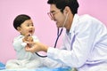 Asian paediatrician examining a baby with a stethoscope Royalty Free Stock Photo