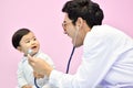 Asian paediatrician examining a baby with a stethoscope Royalty Free Stock Photo