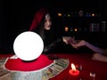 Asian palmist woman reading line on hand fate and spread tarot cards for client choose one from the set