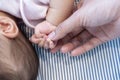 Asian parent hands holding newborn baby fingers, Close up mother's hand holding their new born baby. Love family day Royalty Free Stock Photo
