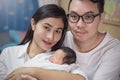 Close up portrait of asian young couple holding their new born baby. Royalty Free Stock Photo