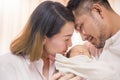 Asian parents with newborn baby, Close up portrait of asian young couple father mother holding kissing their new born baby. Royalty Free Stock Photo