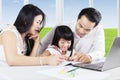 Asian parents teach their daughter to study Royalty Free Stock Photo