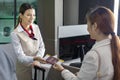 Asian passenger is showing her boarding pass to the airline ground crew at departure gate into the airplane for final inspection