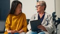 Asian patient doing checkup examination with elderly medic