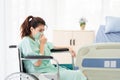 Asian patient sitting on a wheelchair is admitted to observation Royalty Free Stock Photo