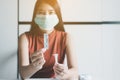 Asian patient woman using a covid-19 self test rapid antigen testing kit at home