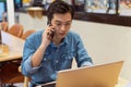 Asian paying man working in a coffee shop