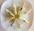 Asian pear Pyrus Pyrifolia with slices on plate isolated on white background closeup.