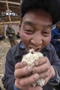 Asian peasant farmer man holding his hands handful of rice