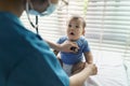 Asian Pediatrician examining lungs of little baby with stethoscope Royalty Free Stock Photo