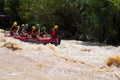 Asian people in action at rafting adventure