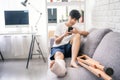 Asian people broken leg with crutches. She recuperates on the sofa at home