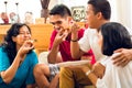 Asian people eating pizza at party