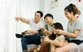 Asian people or friends, having party, playing video games together at home with happiness and fun. Lifestyle Concept Royalty Free Stock Photo