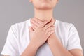 Asian people have a sore throat and touch their neck with their hands. Health care and medical concepts