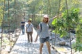 Asian people look happy to pose, they are Standing on the wooden bridge, the beautiful natural landscape