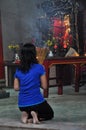 Asian people praying and burning incense sticks in a pagoda Royalty Free Stock Photo