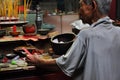 Asian people praying and burning incense sticks in a pagoda Royalty Free Stock Photo