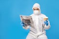 Asian people in protective clothing complete with gloves and masks. She is reading a newspaper and hot coffee in the studio on a