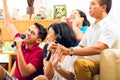 Asian people singing at karaoke party Royalty Free Stock Photo