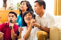 Asian people singing at karaoke party Royalty Free Stock Photo