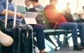 People sitting and working on tablet when waiting for delayed flight