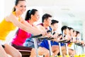 Asian people in spinning bike training at fitness gym Royalty Free Stock Photo