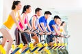 Asian people in spinning bike training at fitness gym Royalty Free Stock Photo