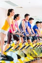 Asian people in spinning bike training at fitness gym Royalty Free Stock Photo